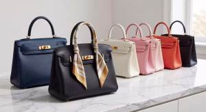 Elegant luxury designer handbag collection displayed on marble surface with soft natural lighting, H