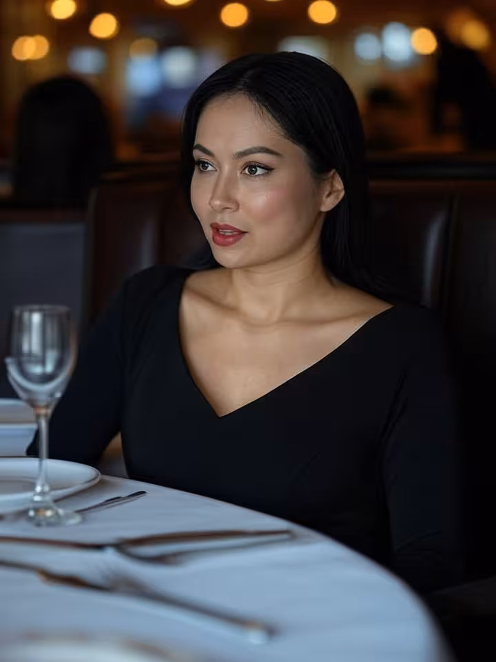 Confident woman having serious conversation in upscale restaurant booth, intimate lighting, sophisti